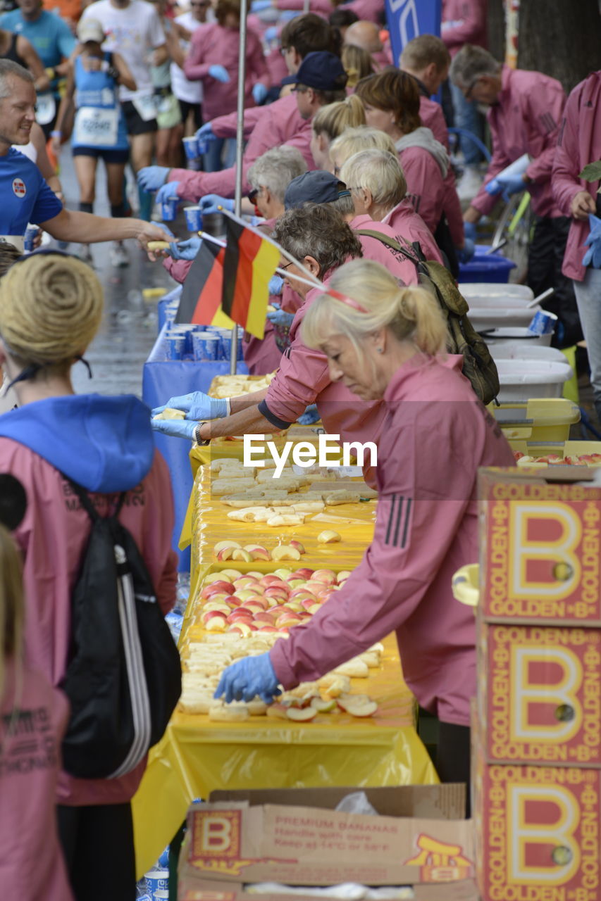 REAR VIEW OF PEOPLE ENJOYING AT MARKET