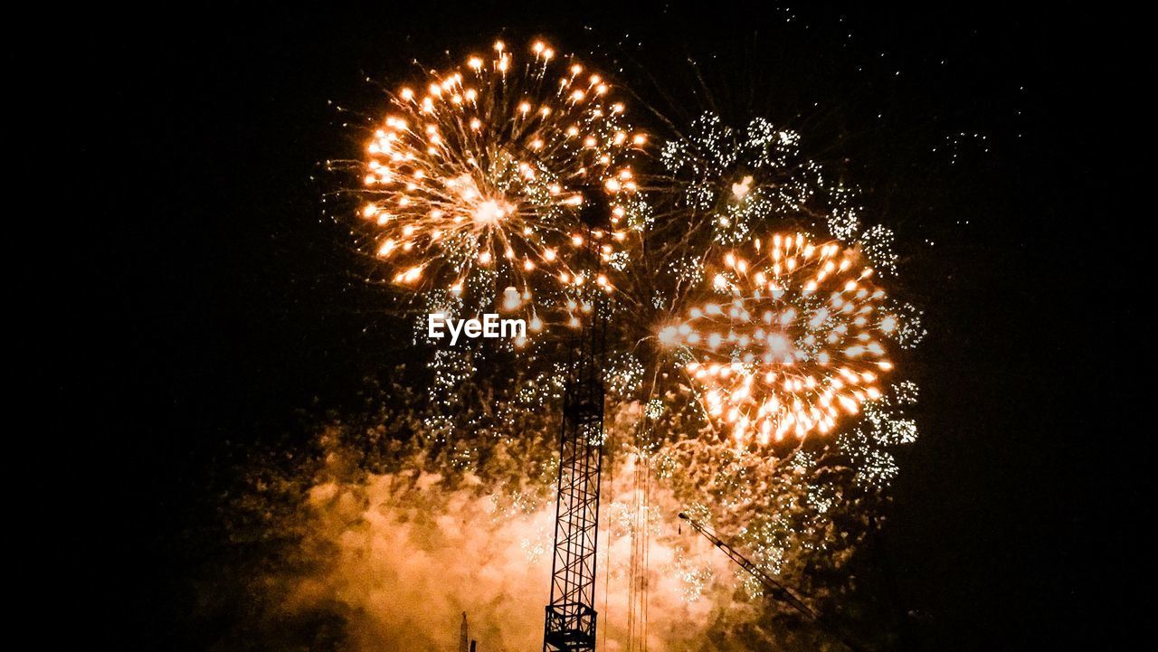 Low angle view of firework display in sky