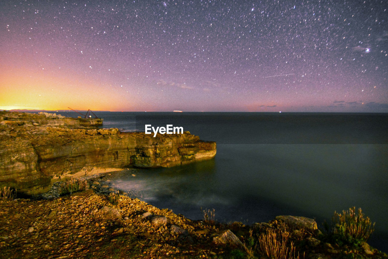 Scenic view of sea against sky at night