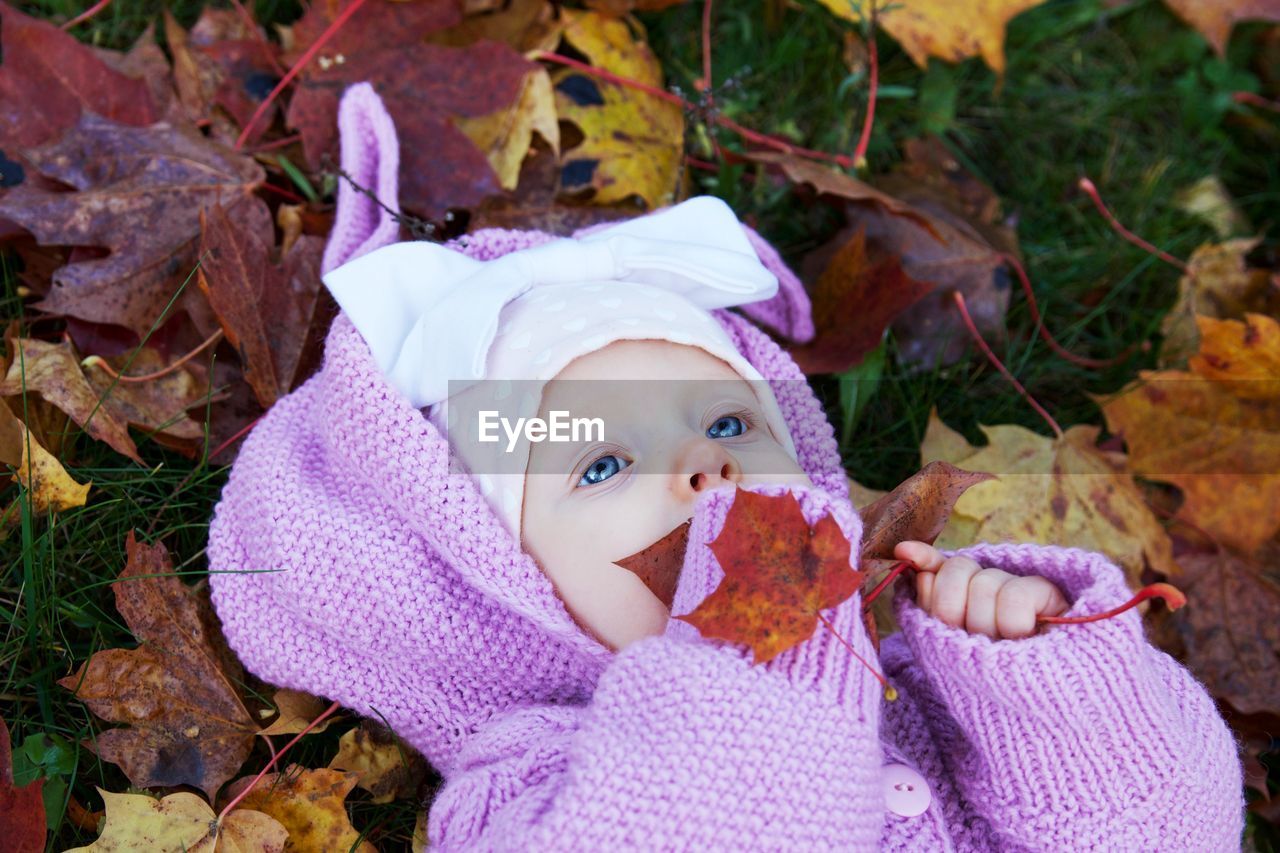 PORTRAIT OF A BABY GIRL WITH LEAVES