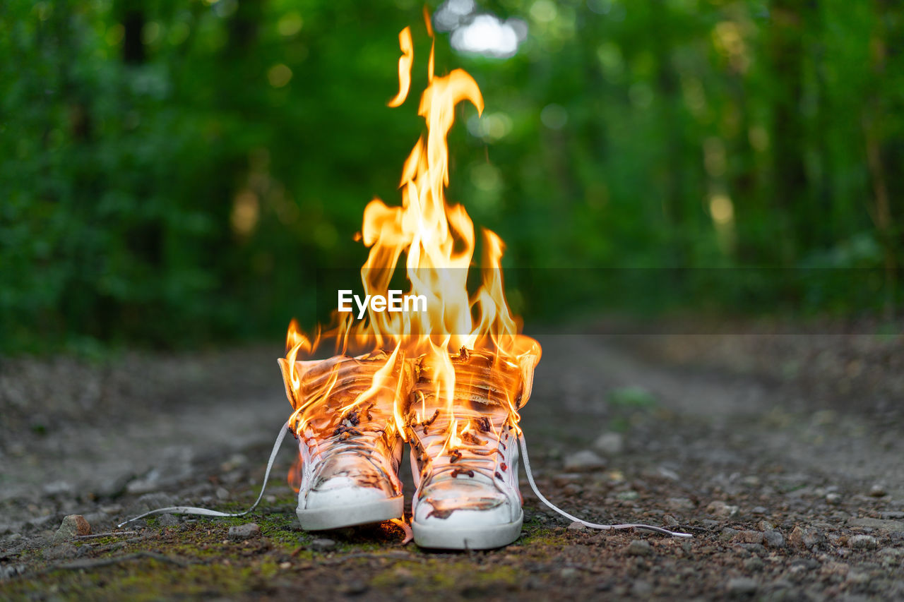 Shoes burning in forest