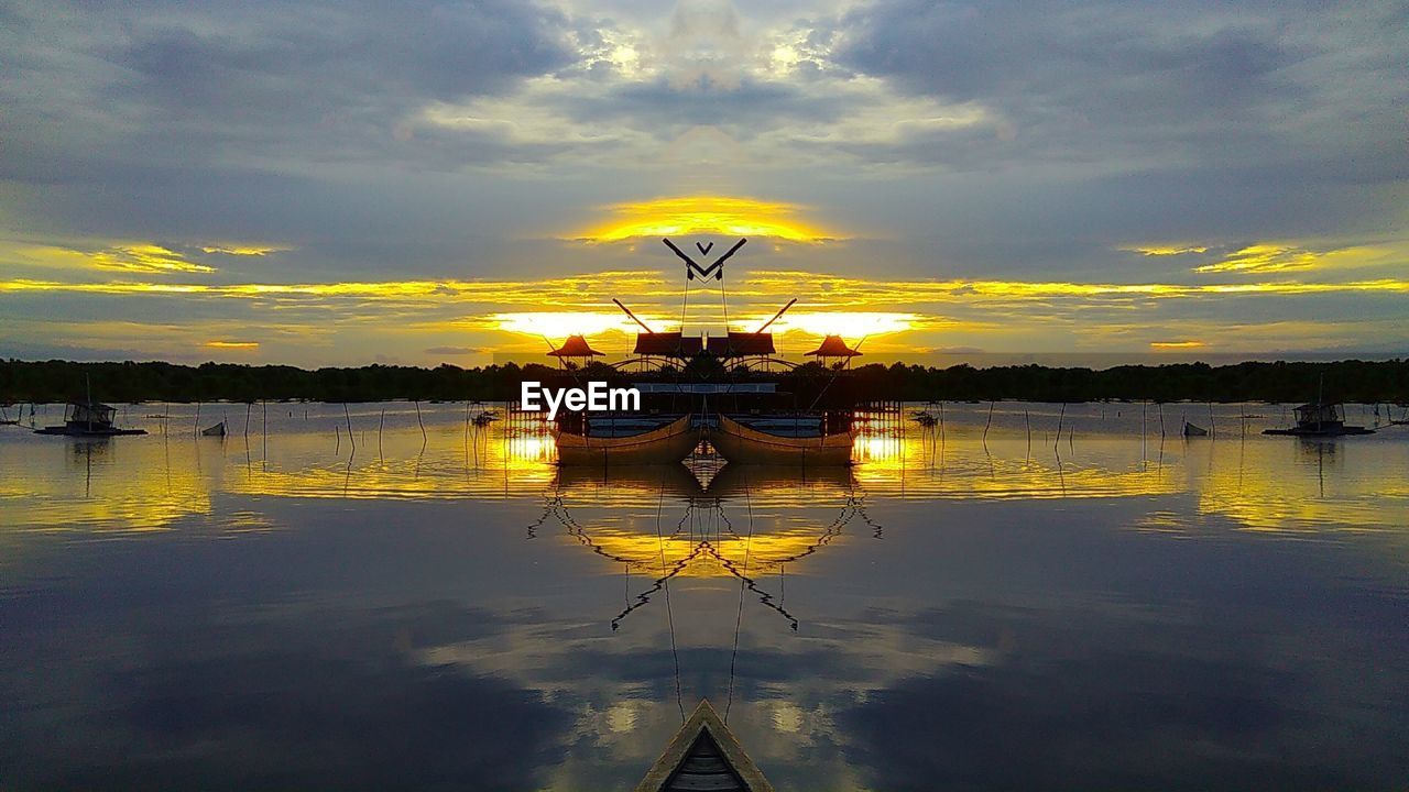 SCENIC VIEW OF LAKE DURING SUNSET AGAINST SKY