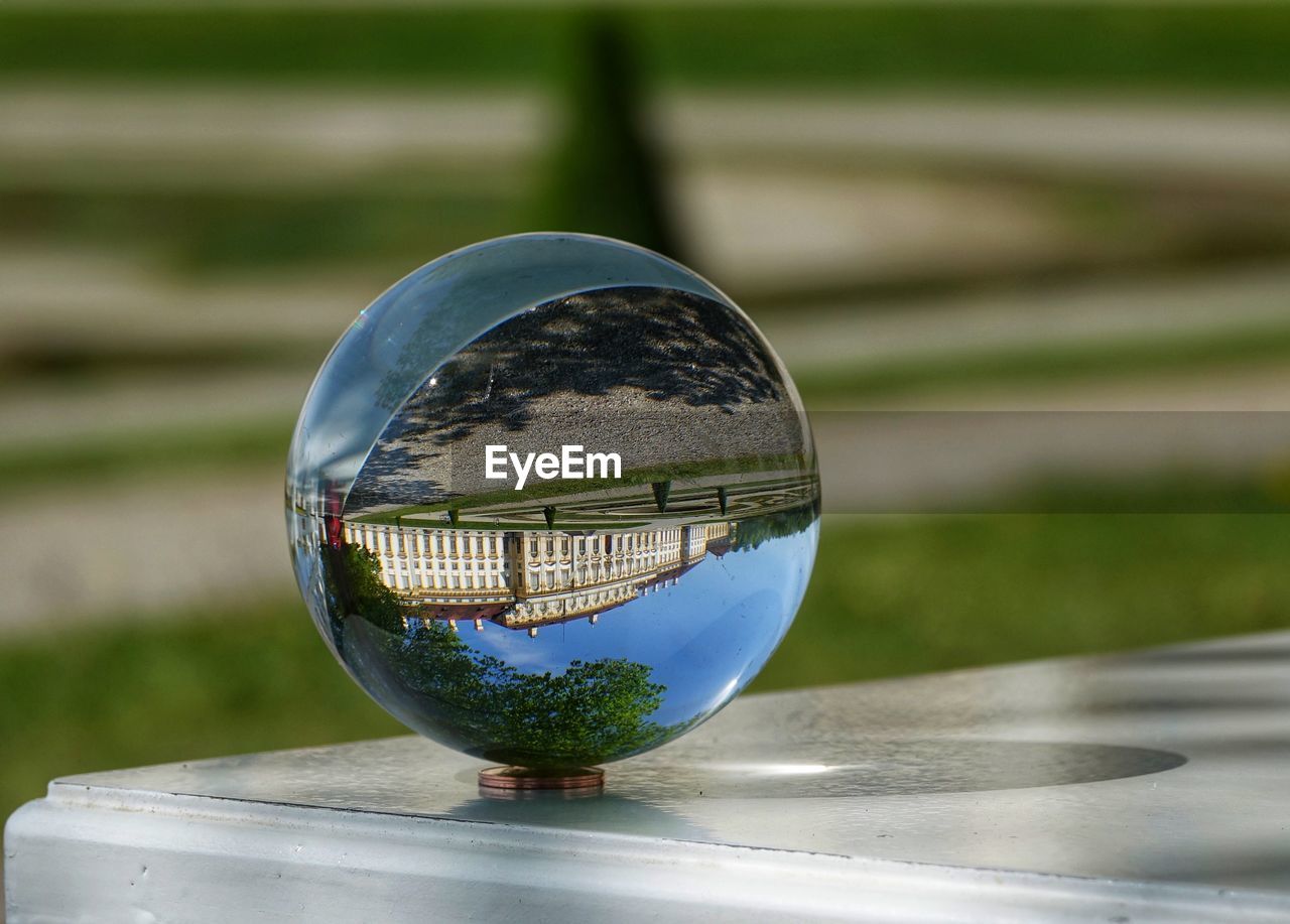 CLOSE-UP OF CRYSTAL BALL ON METAL