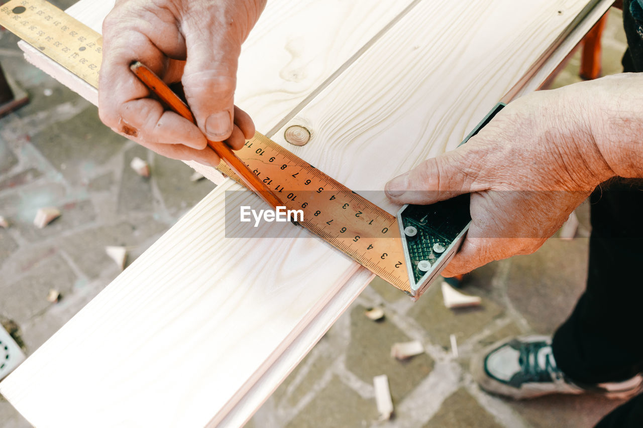 cropped image of man working on wood