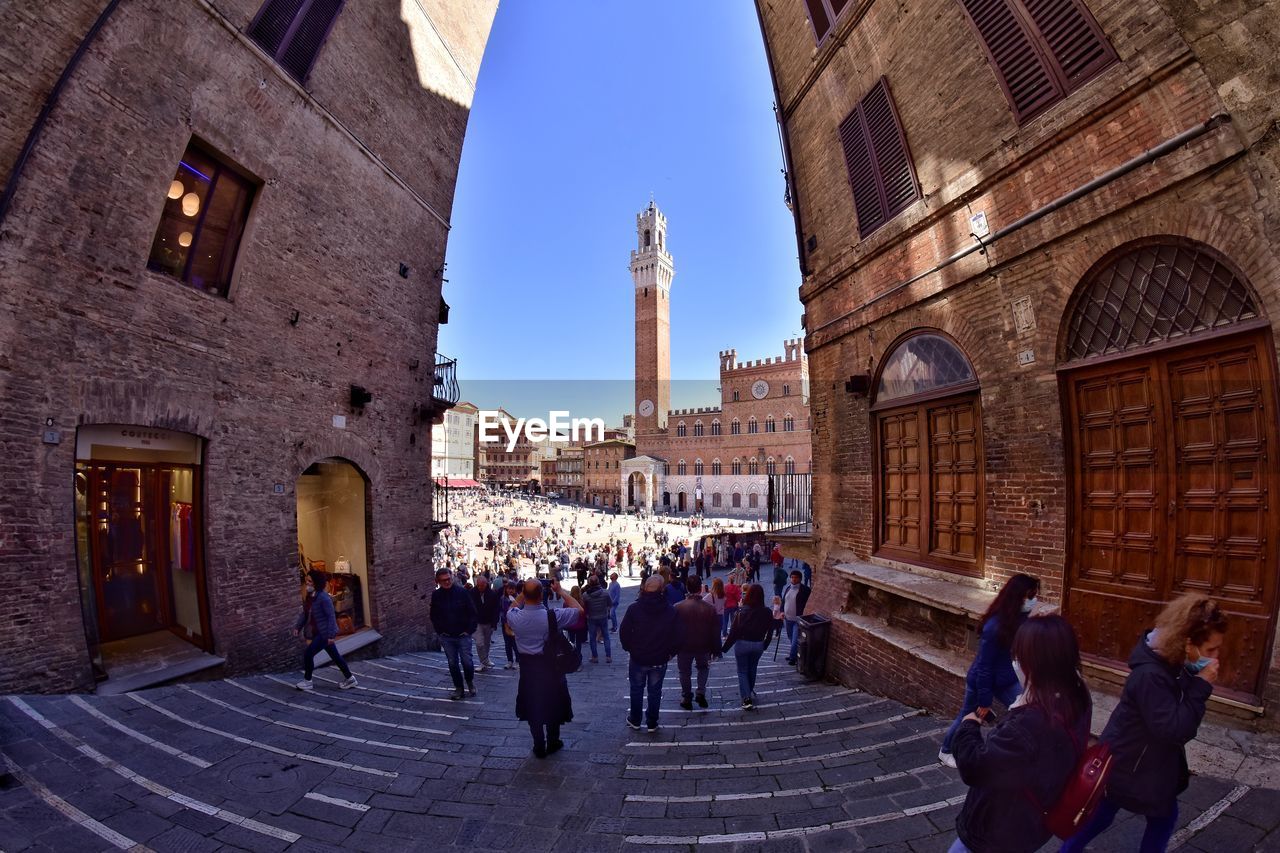 People walking in front of historic building