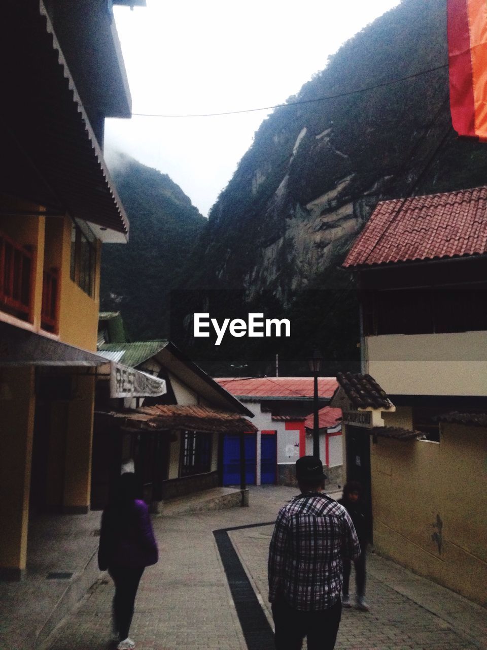 WOMAN STANDING ON TOP OF HOUSE