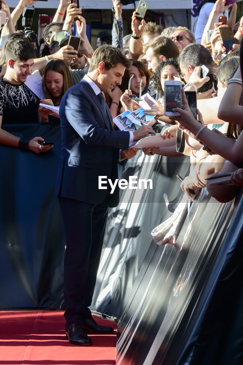 CROWD PHOTOGRAPHING WITH MOBILE PHONE IN TRADITIONAL CLOTHING