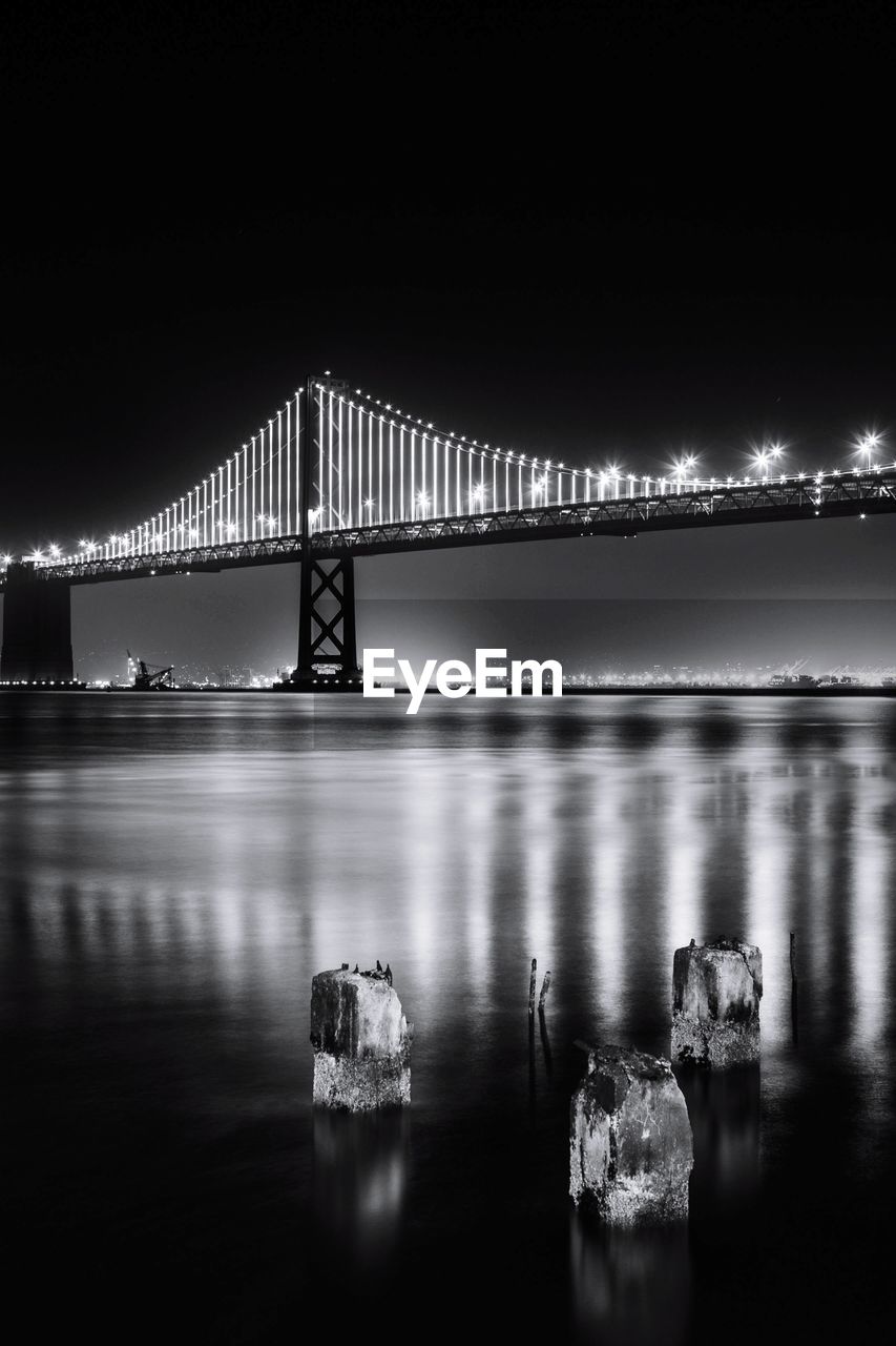 water, black and white, bridge, built structure, architecture, darkness, monochrome photography, reflection, monochrome, night, transportation, travel destinations, illuminated, light, nature, sky, suspension bridge, engineering, sea, travel, city, black, dusk, tourism, outdoors, building exterior, waterfront, copy space, long exposure