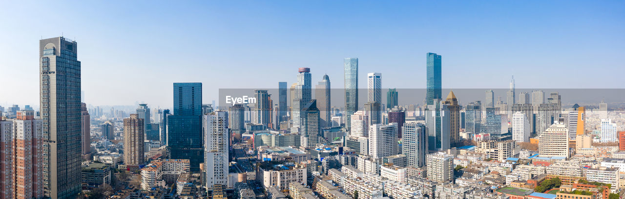 Aerial view of modern buildings in city against sky