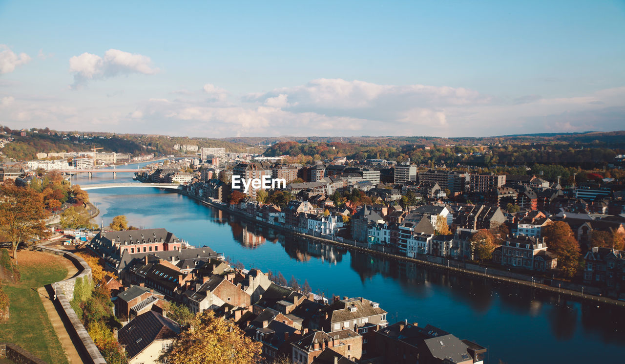 Aerial view of cityscape by sea against sky