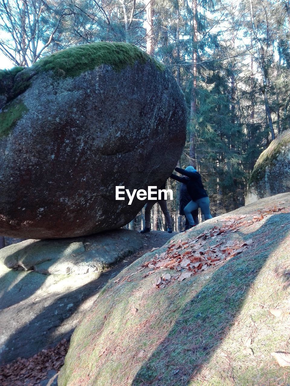 Man pushing rock