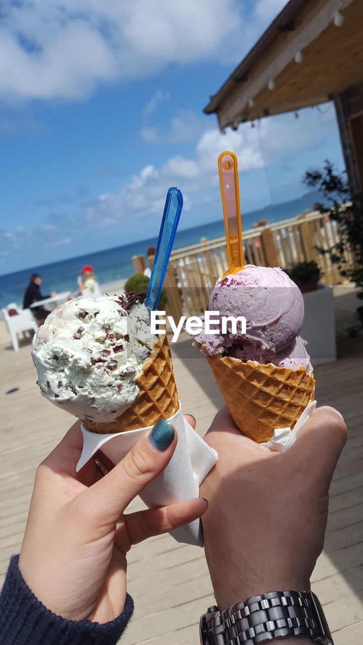 Cropped image of hands holding ice cream cones