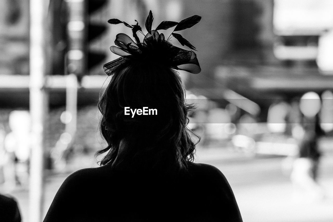 REAR VIEW PORTRAIT OF WOMAN STANDING OUTDOORS