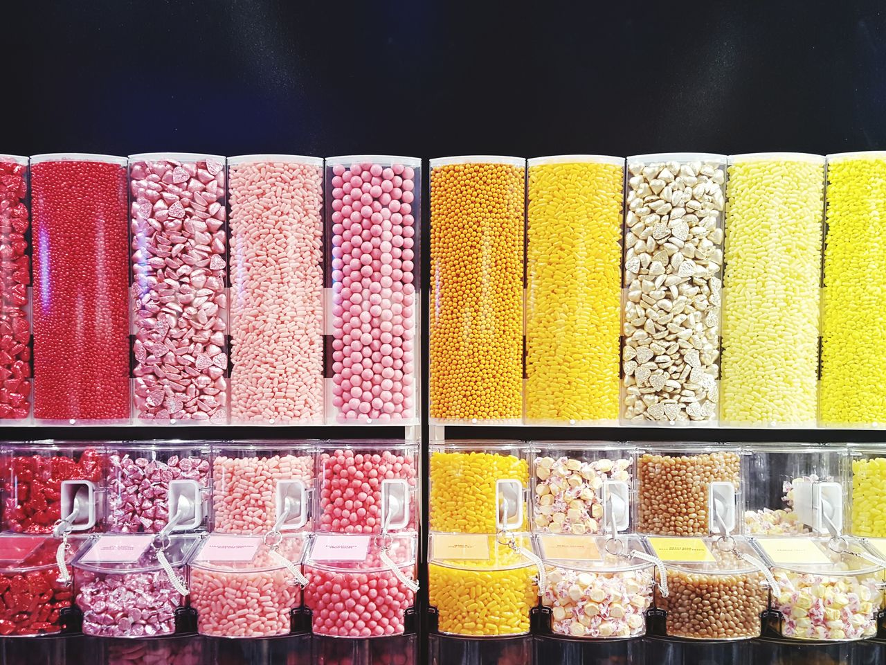 Row of candy dispensers at store