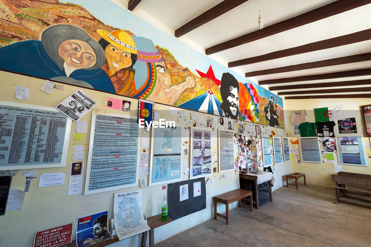 Posters and paintings on wall of historic school at la higuera