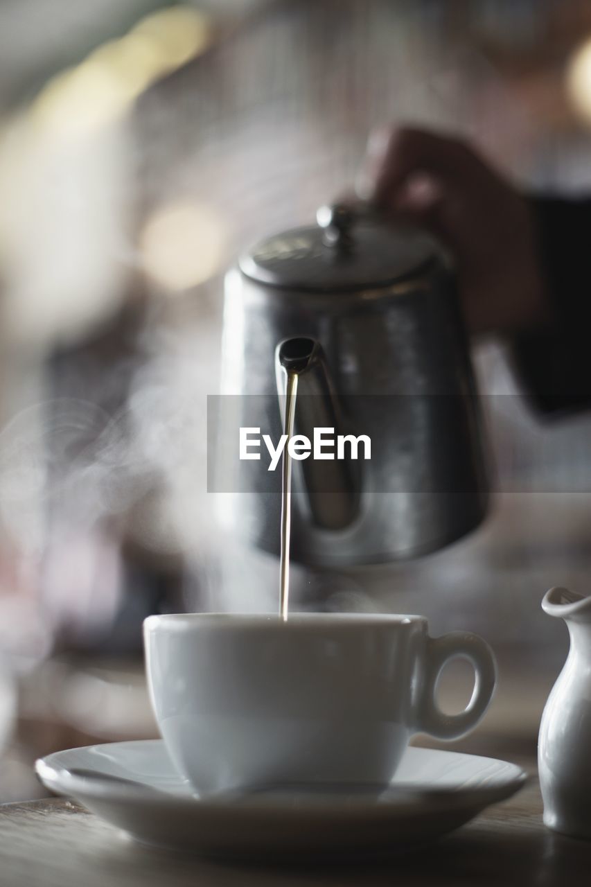 CLOSE-UP OF COFFEE CUP ON TABLE IN KITCHEN