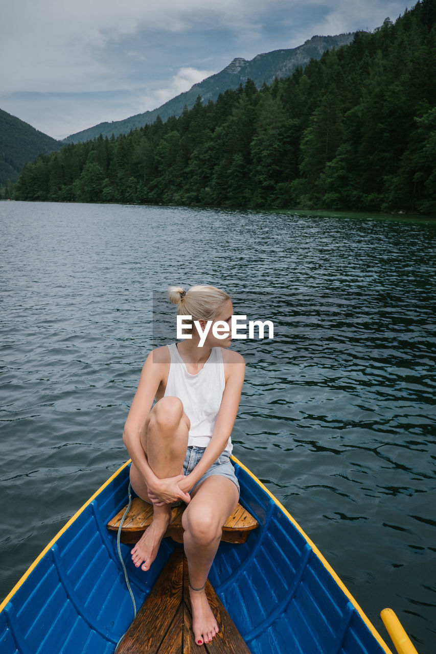 Woman sitting on boat in lake