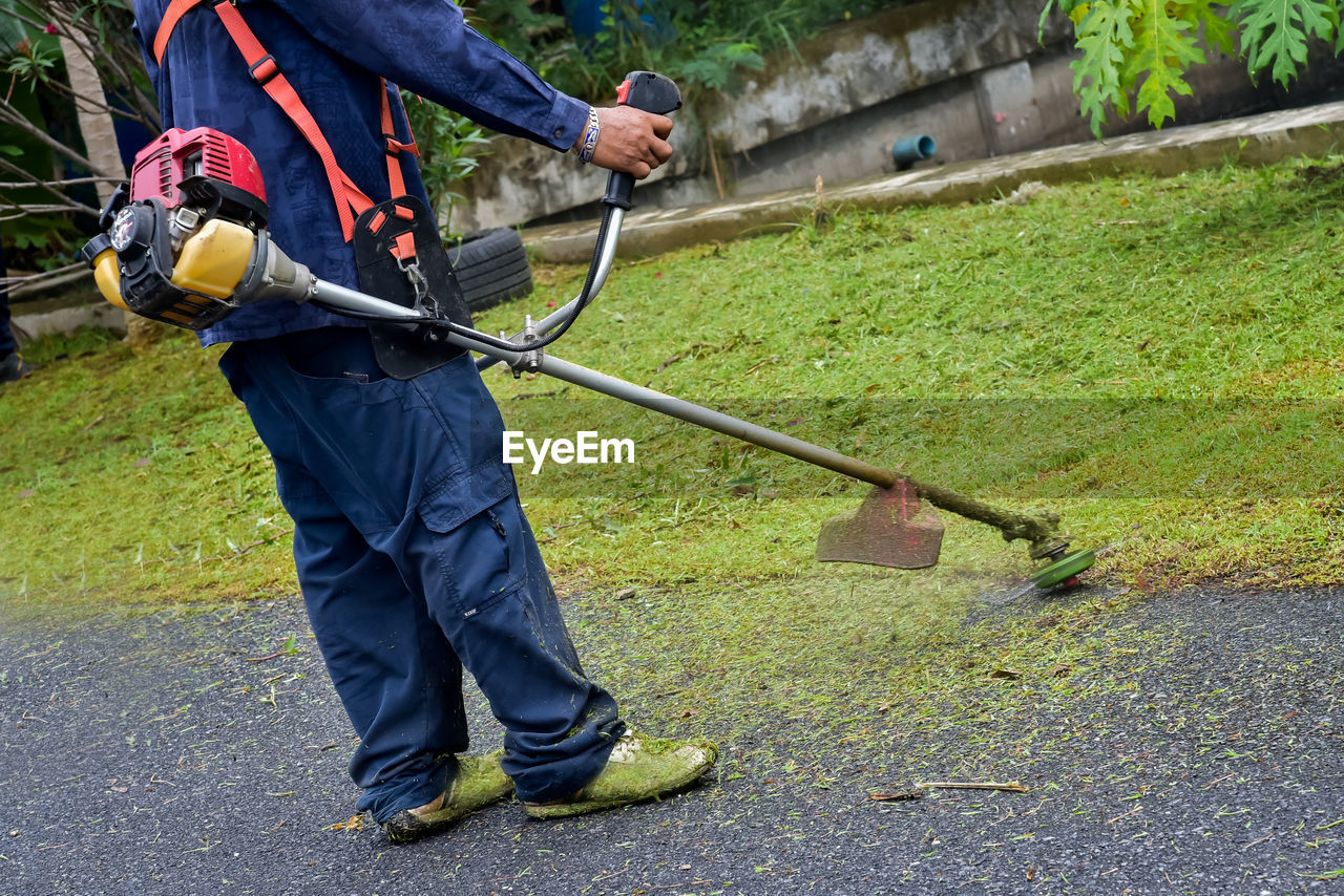 Low section of man working on road