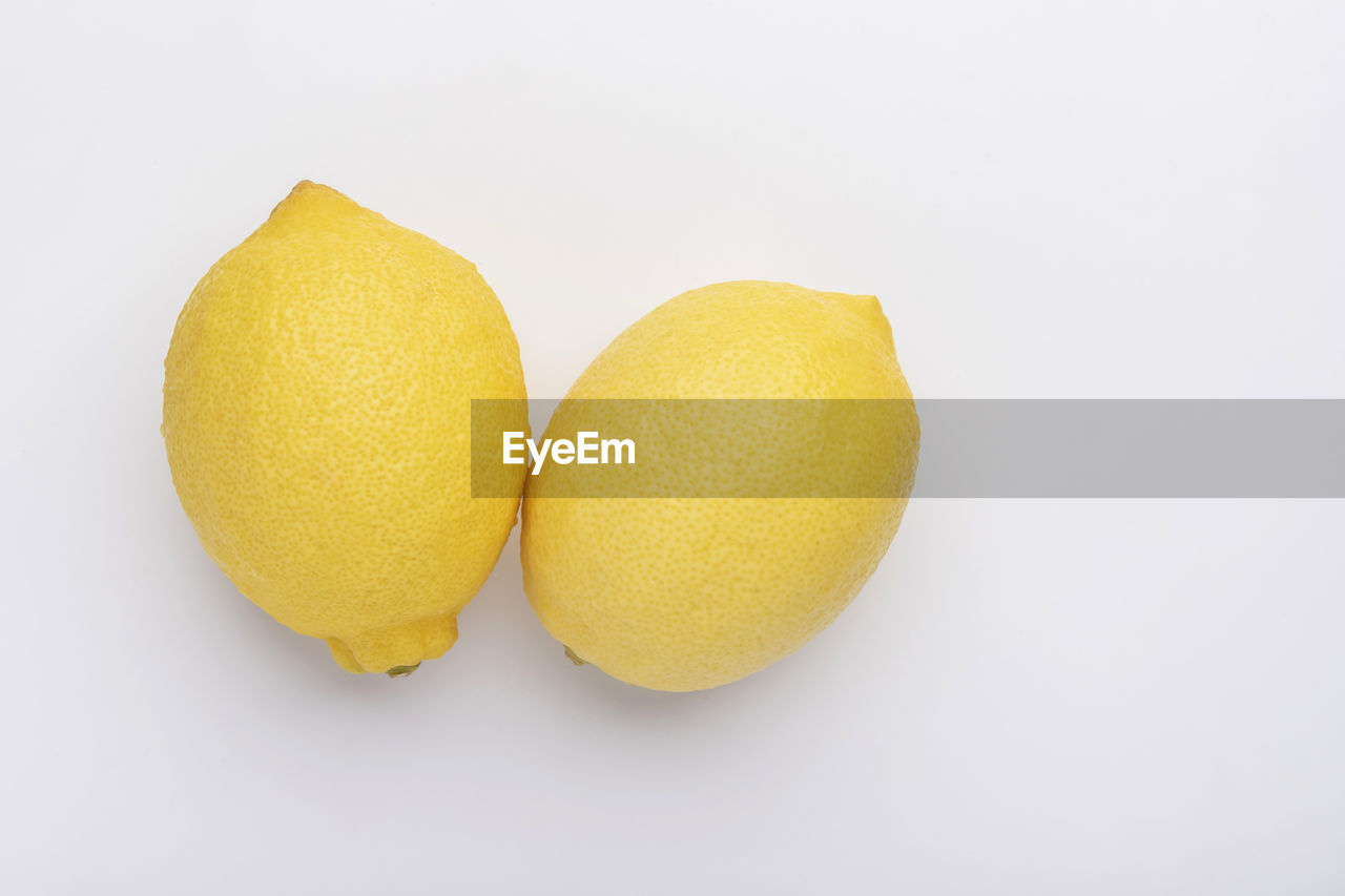 food and drink, food, healthy eating, citrus, fruit, produce, wellbeing, freshness, citrus fruit, plant, studio shot, yellow, indoors, white background, lemon, no people, cut out, close-up, still life, two objects, group of objects, organic, orange color