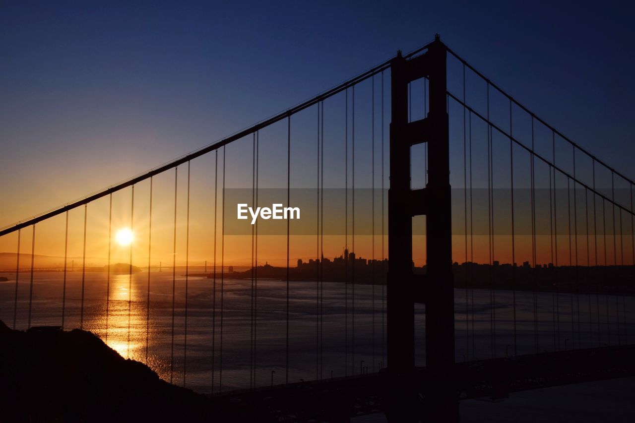 View of suspension bridge against sky during sunset