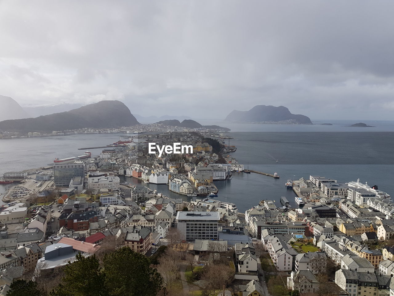 High angle view of city by sea against sky