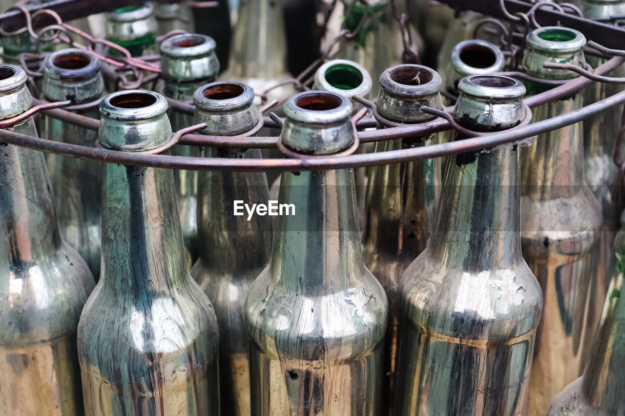 Close-up of old bottles in factory