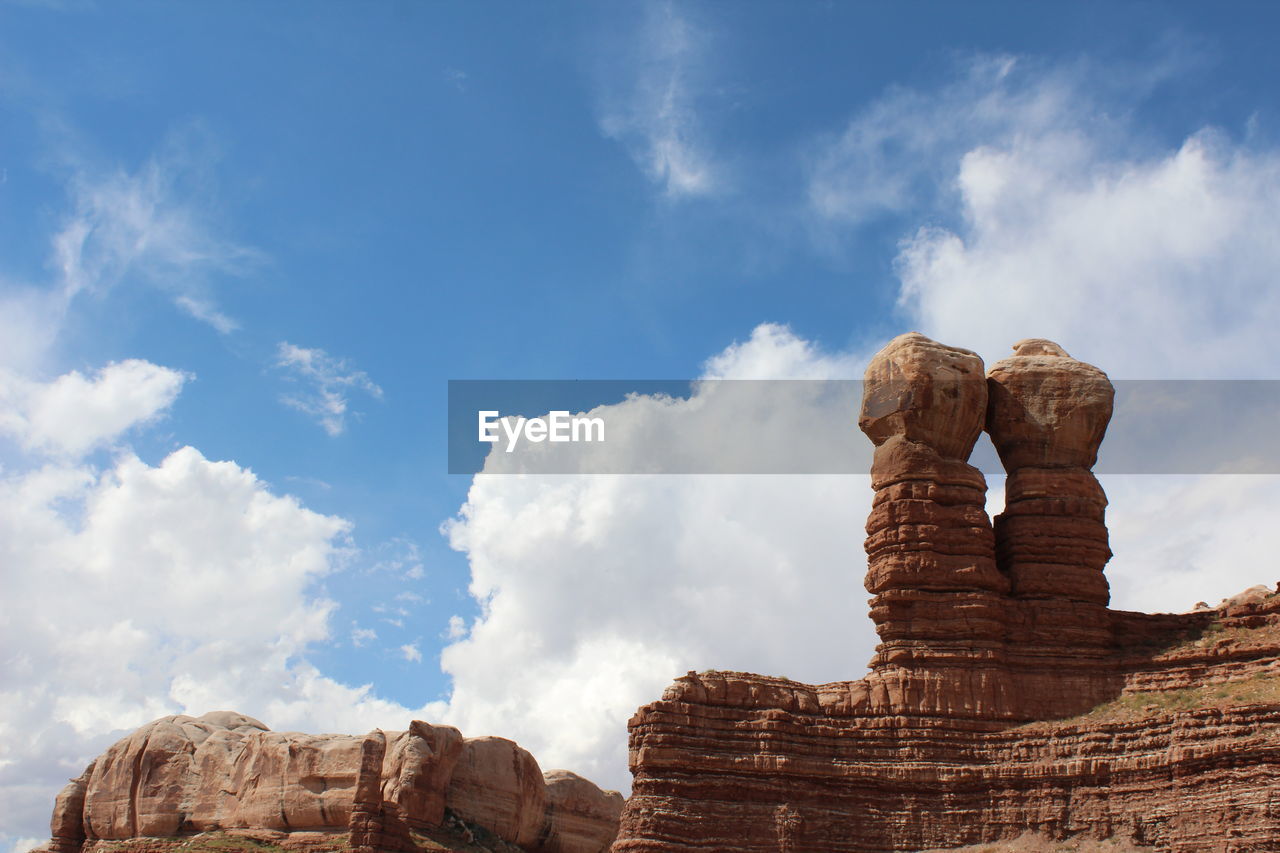 sky, cloud, rock, travel destinations, rock formation, nature, travel, landscape, arch, environment, scenics - nature, geology, beauty in nature, land, no people, ancient history, landmark, temple, non-urban scene, tourism, outdoors, desert, day, mountain, architecture, tranquility, blue, physical geography, history, monument, tranquil scene