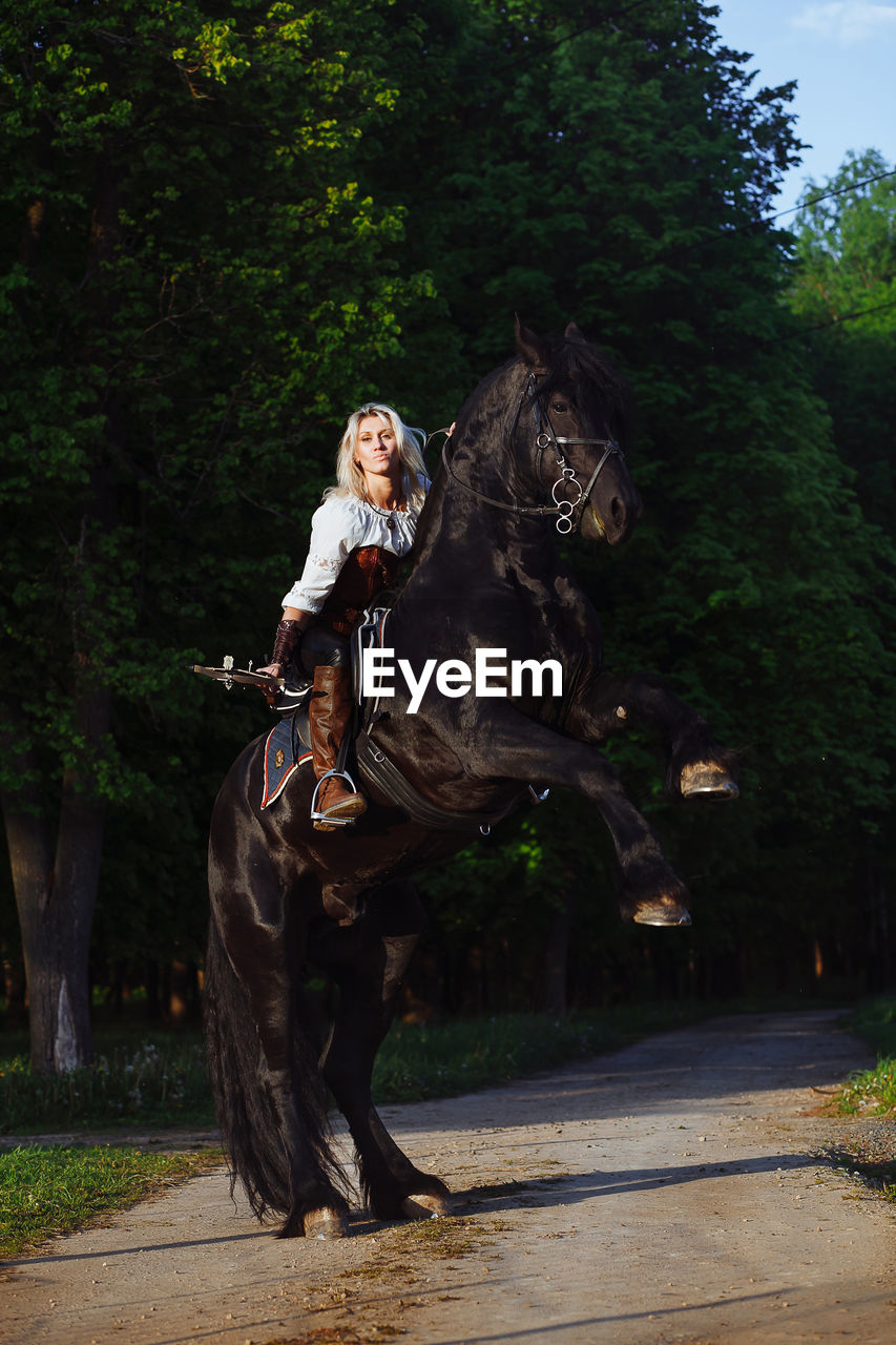 Portrait of young woman riding horse