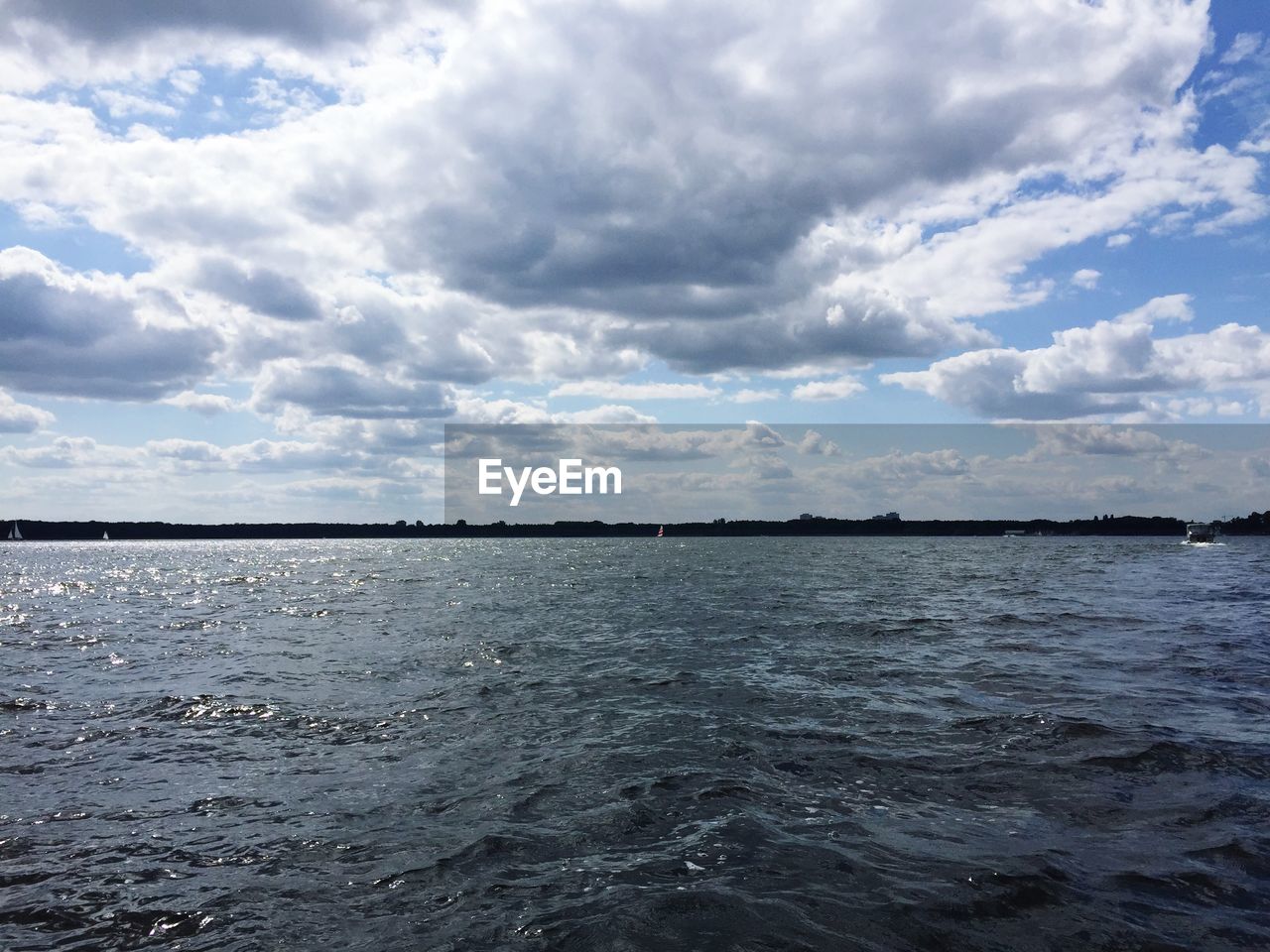 VIEW OF SEA AGAINST CLOUDY SKY