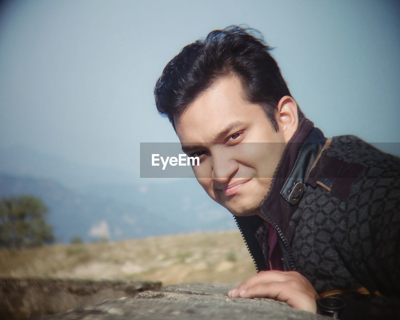 PORTRAIT OF HANDSOME YOUNG MAN AGAINST SKY