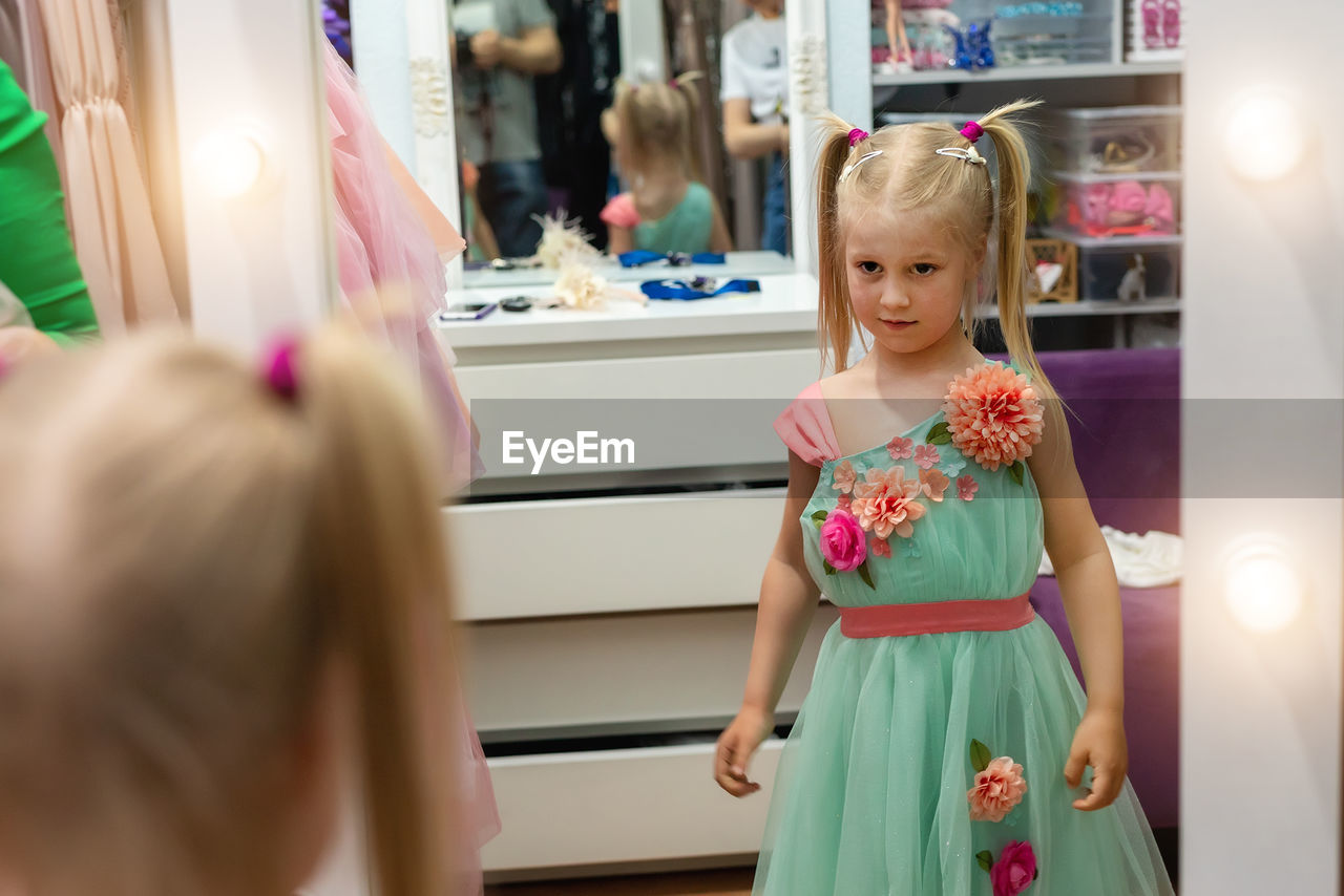 Cute girl looking in mirror