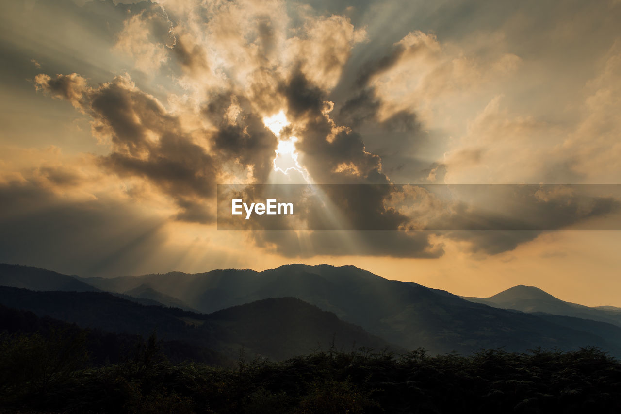 Scenic view of silhouette mountains against sky during sunset