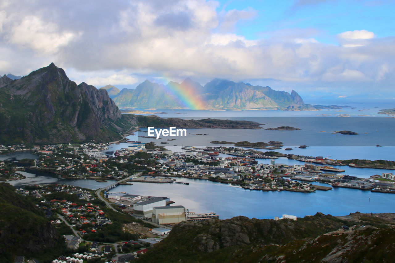 Scenic view of sea and mountains against sky