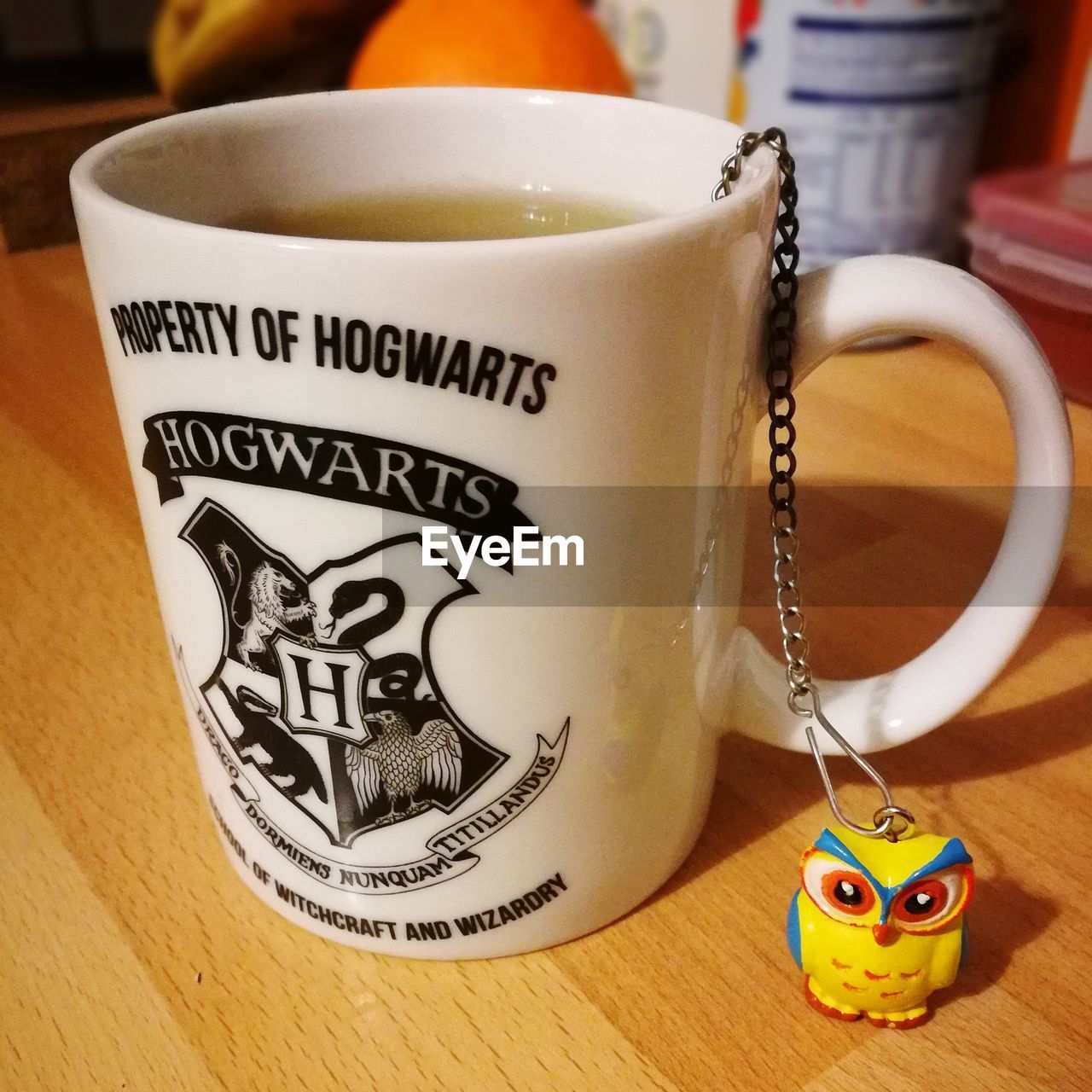 CLOSE-UP OF COFFEE CUP ON TABLE WITH TEXT