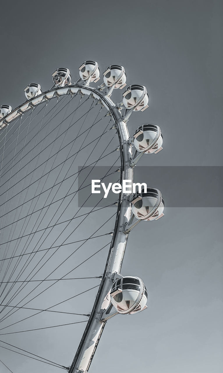 Low angle view of ferris wheel against sky
