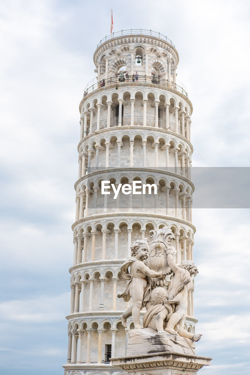 LOW ANGLE VIEW OF TOWER OF BUILDING AGAINST CLOUDY SKY