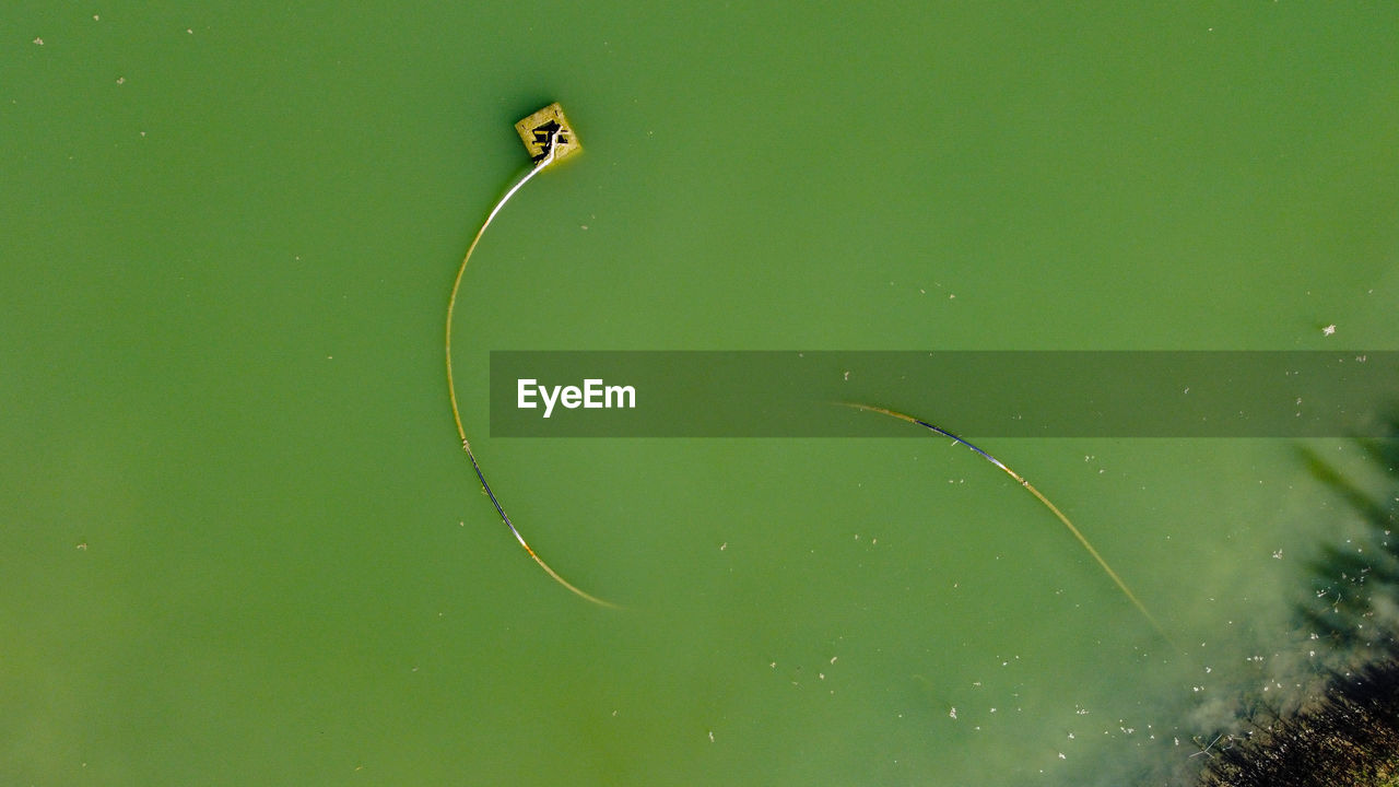 Aerial view from the drone of water pond with tube with snake shape