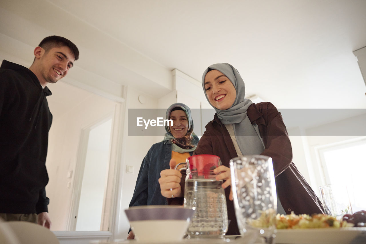 Family setting table for eid al-fitr together at home