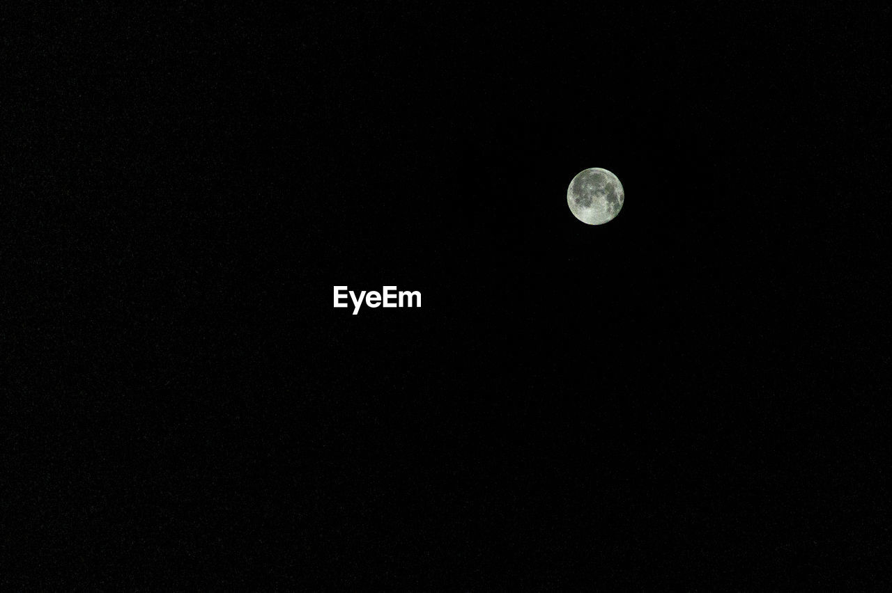 Low angle view of moon against sky at night