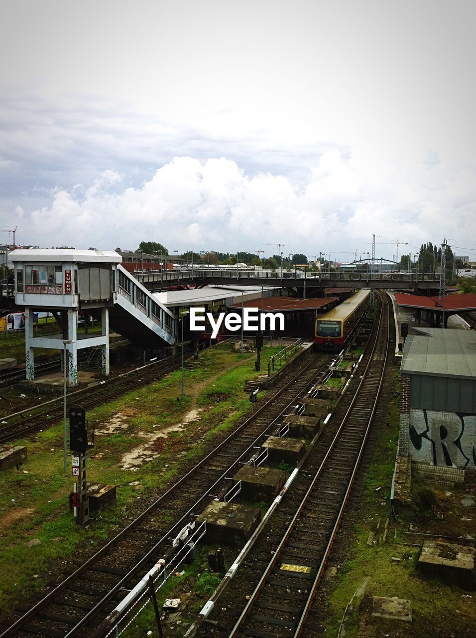 High angle view of train warschauer strasse station against cloudy sky