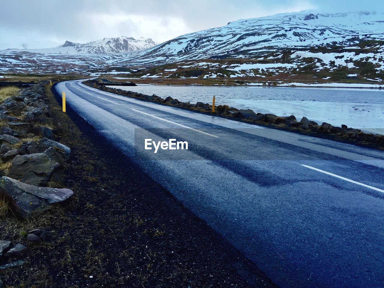 Empty road against snowed landscape