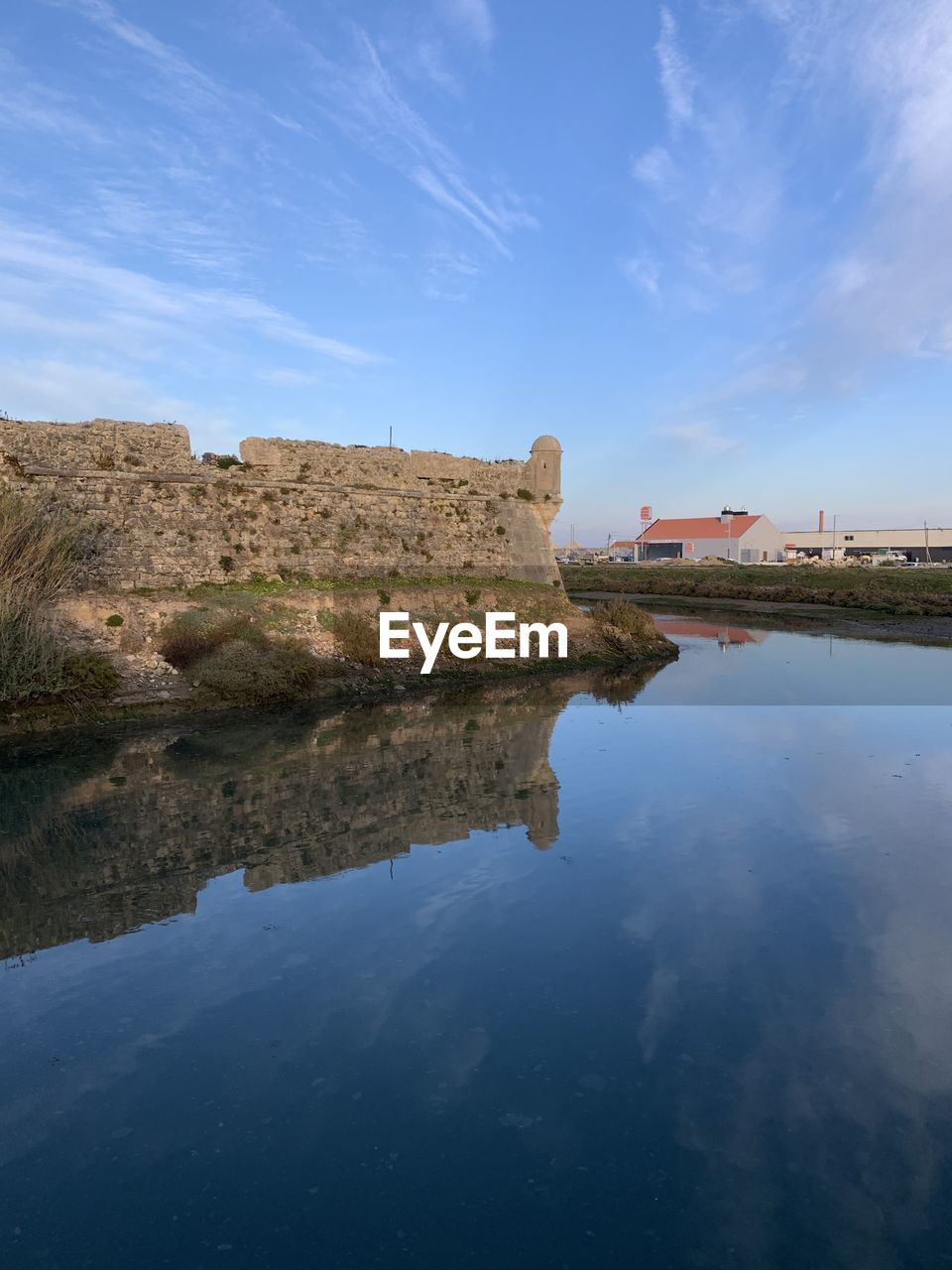 sky, nature, cloud, architecture, blue, tower, reflection, low angle view, history, terrain, outdoors, the past, built structure, no people, travel destinations, day, travel, land, panoramic, religion, cliff, scenics - nature, landmark, tree