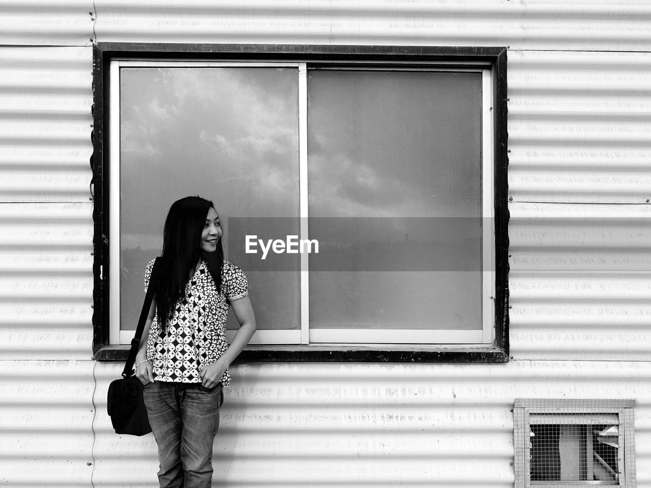 Woman standing against window