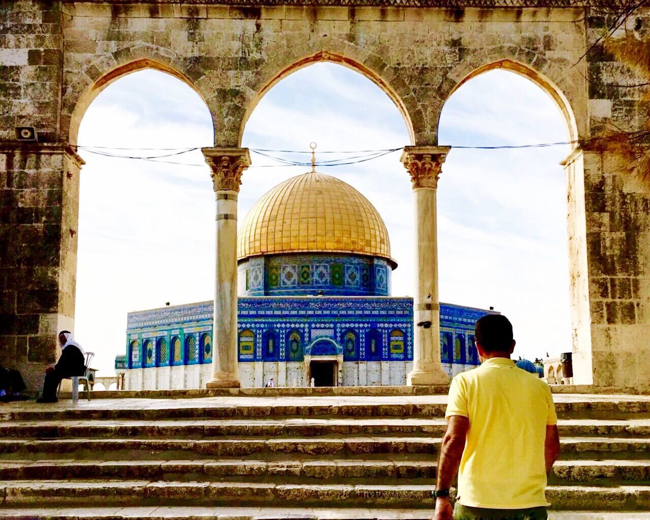 REAR VIEW OF PEOPLE AT TEMPLE