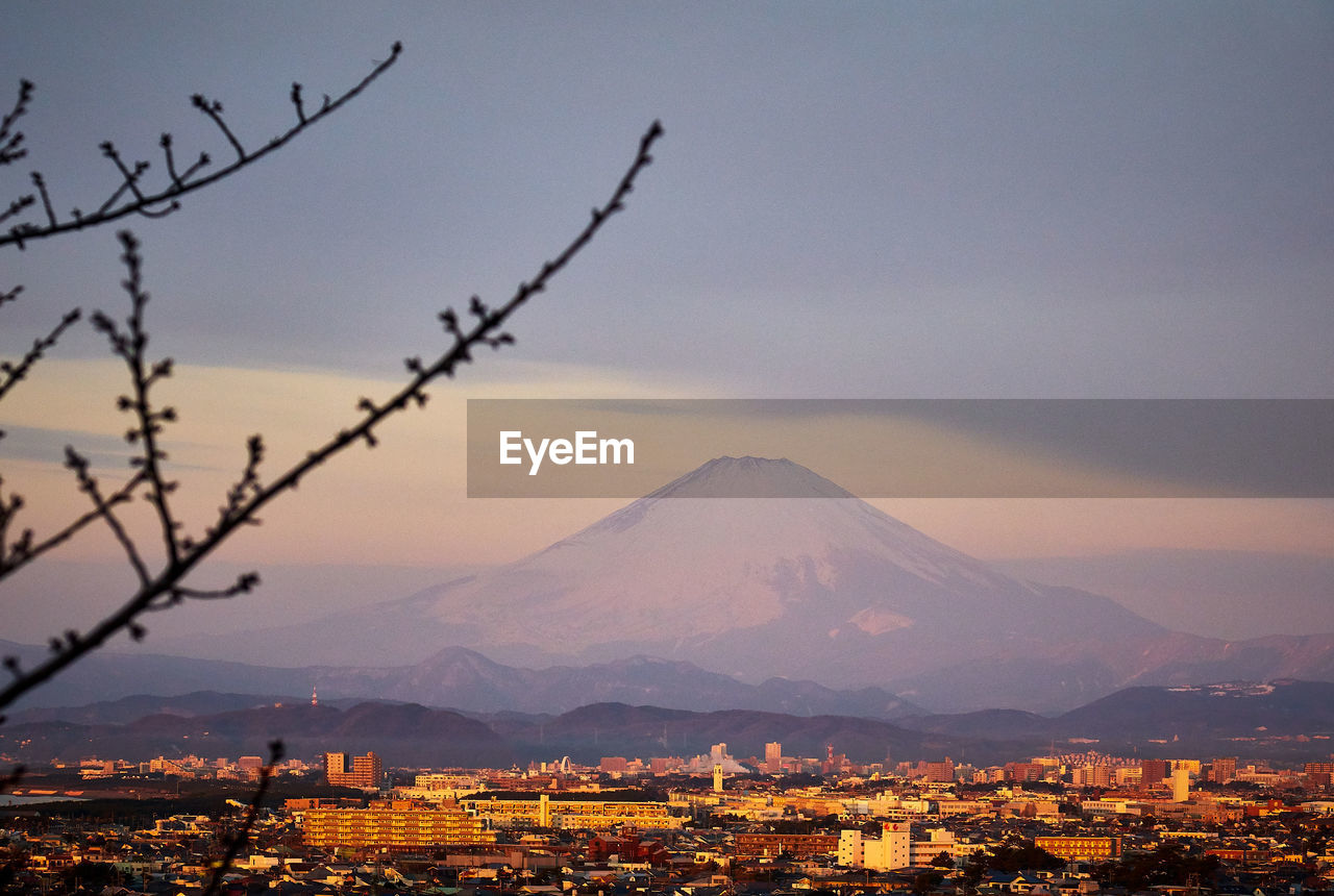 Aerial view of cityscape against sky during sunset