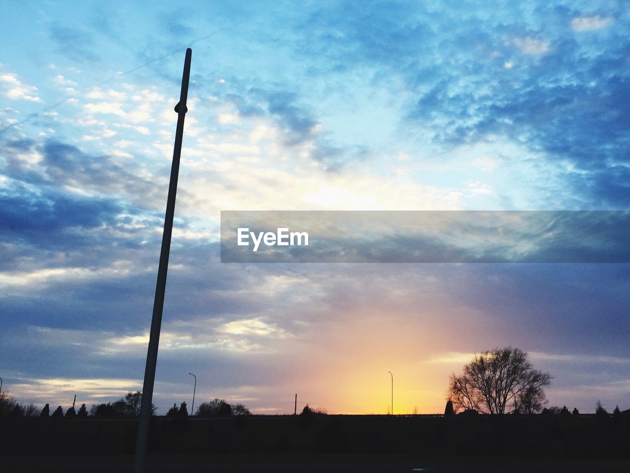 SILHOUETTE OF LANDSCAPE AGAINST SKY AT SUNSET