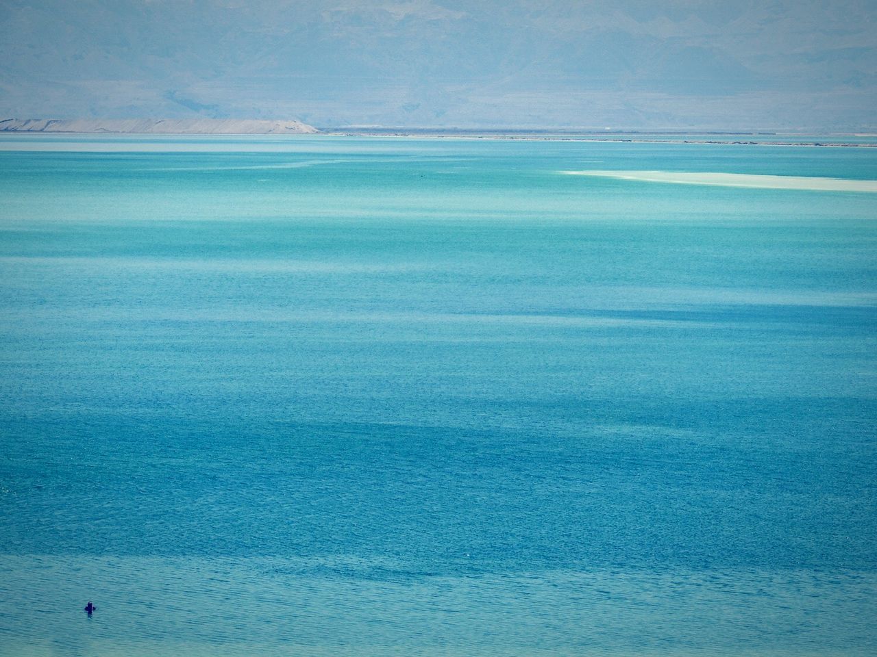 Scenic view of turquoise sea against sky