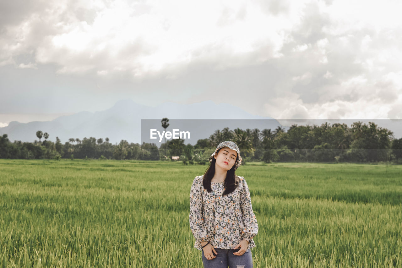 Young woman standing in field