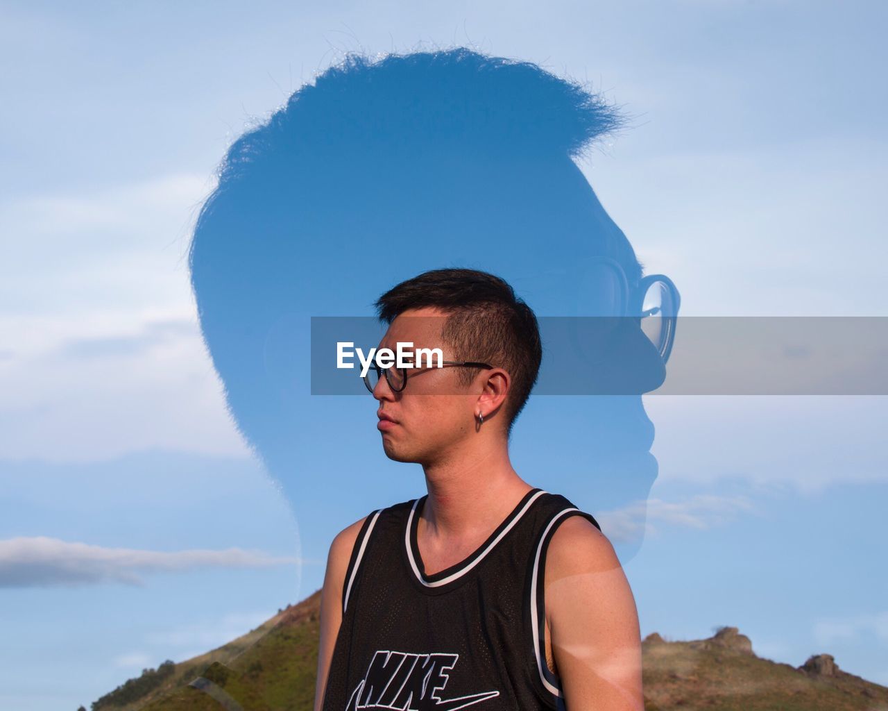 MAN IN EYEGLASSES AGAINST SKY