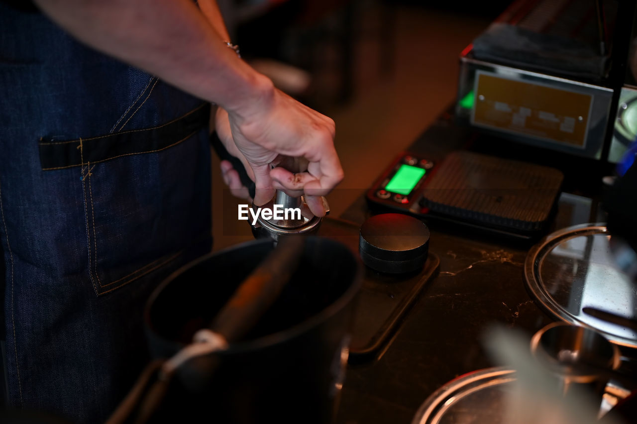 cropped hand of man preparing food on table